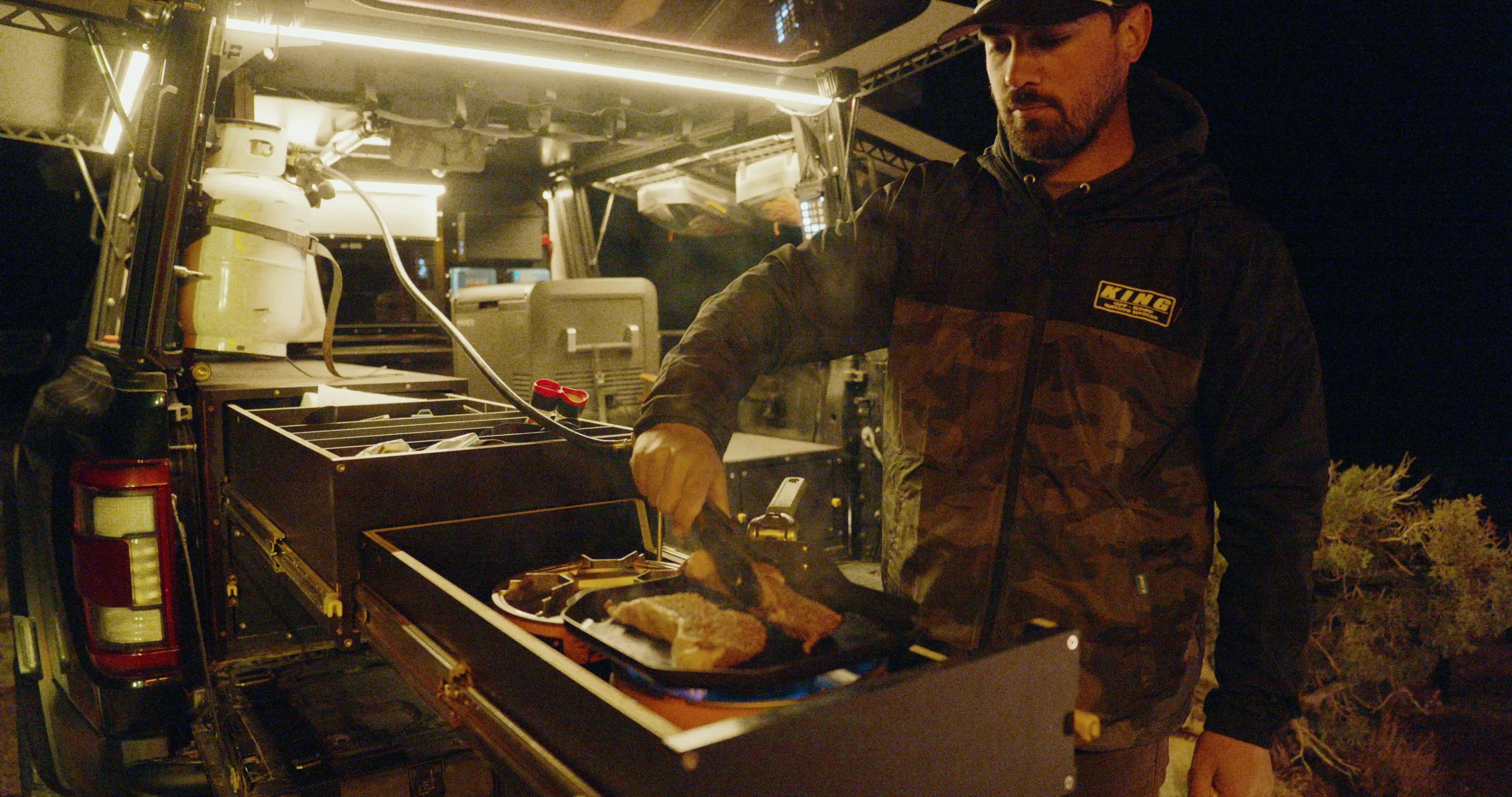Person cooking inside a vehicle at night