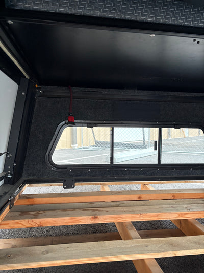 Used Tall V1 — Toyota Tacoma 5 ft Bed — additional angle of the completed build; solar wiring port (driver side)
