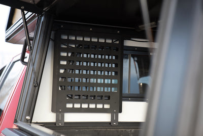 MOLLE Panel — powdercoated steel MOLLE panel that mounts to the Camper V2 cab section T-slots; angled rigidity edges, flexible left/middle/right positioning